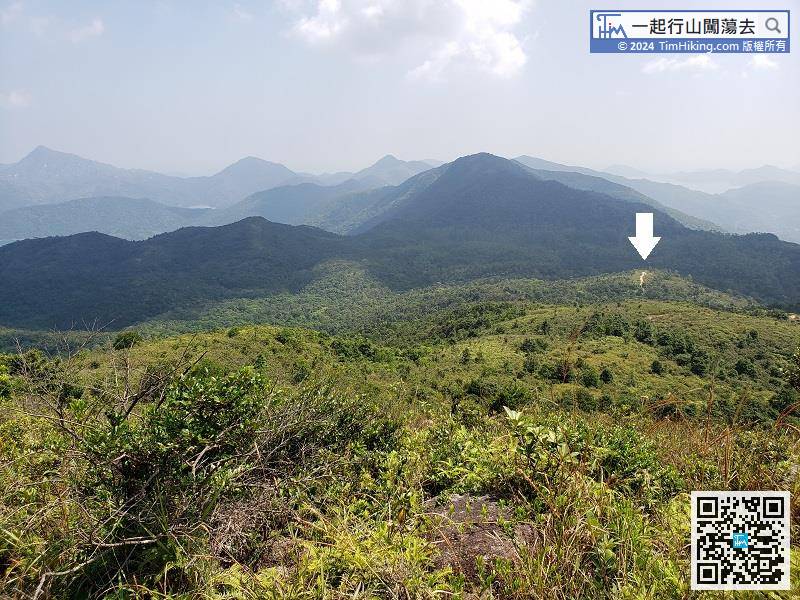 While descending, can clearly see a wide mountain trail in the upper right and far away, which is the downhill direction.