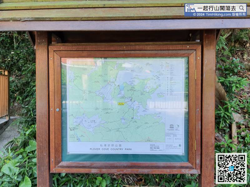 There is a clear map bulletin board at the intersection,
