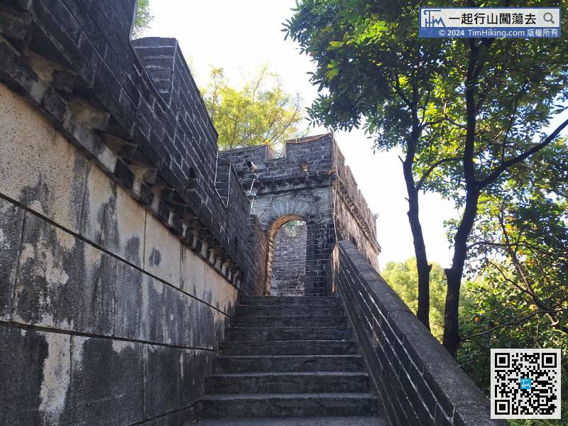 Climb up the Mini Great Wall along the big stone steps.