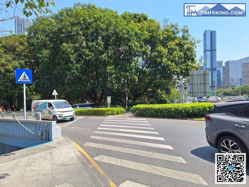 Go to the intersection and cross the road.