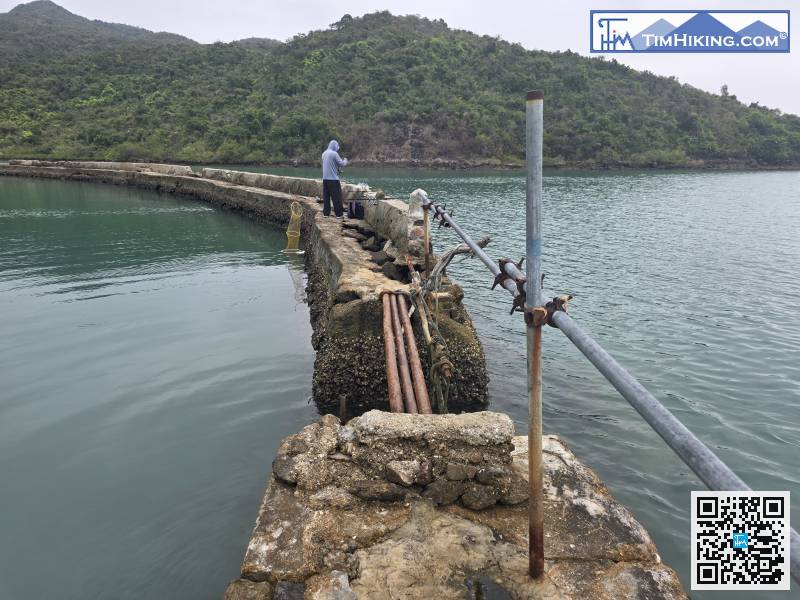 To pass the dike, must cross a sluice gate that was destroyed by typhoon Mangkhut earlier.